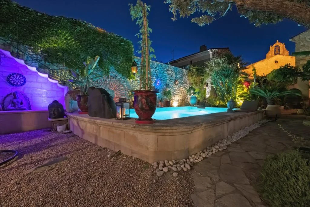votre week end amoureux en occitanie, la cour intérieure tout en pierre avec sa piscine et ses lumières led et bougies